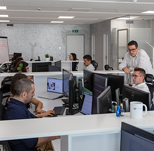 Employees of ITR Services, including Mr. Svetoslav Marinov working in a modern office.