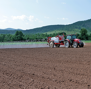 Tractor cultivating agricultural land of Geogreenland.