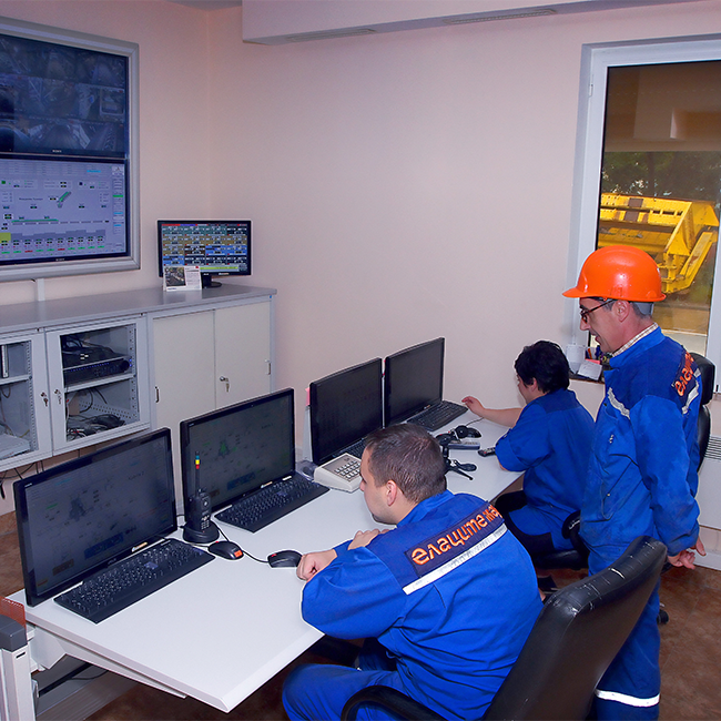 Ellatzite-Med employees in work clothes working in a control room.