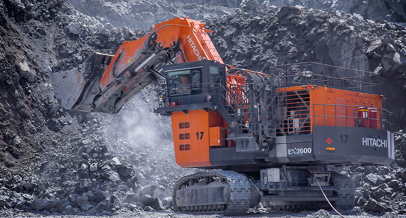 Excavator digging on a work site.